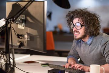 Wall Mural - man working on computer in dark startup office