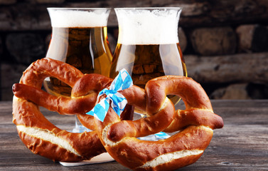 Original bavarian pretzels with beer on wooden board. Oktoberfest background