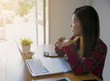 © EKKAPON - Relaxed business woman sitting in office