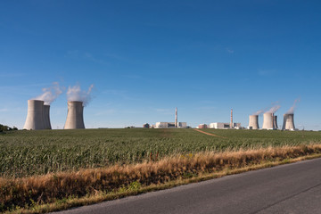 Aerial view of nuclear power station with  cooling towers against blue sky