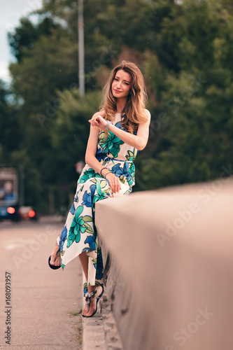 Cute Looking Girl Giving A Naughty Expression Sitting On The Bridge Over The Lake And Indulged Herself Into Thoughts Recalling Some Funny Incidents And Laughing Alone In The Evening Buy This Stock funny incidents and laughing alone