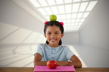 Poster - Composite image of smiling girl with granny smith apple on head