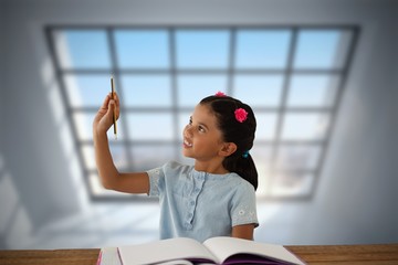 Poster - Composite image of girl looking at pencil while sitting at desk 