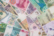 many different currency banknotes from world country as background