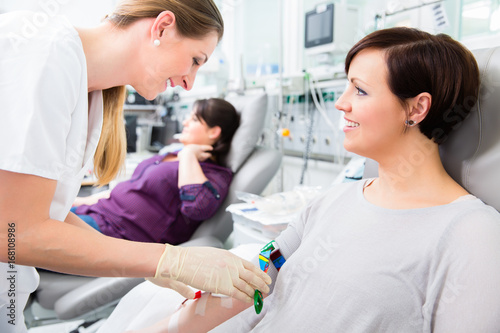 Fotomural Nurse in drop-in department or clinic taking blood from woman donor