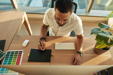 Wall Mural - Male creative profession at his work desk