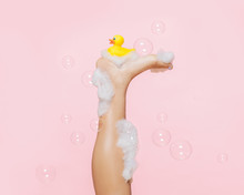 Bubblebath Leg With Rubber Ducky And Large Bubbles, On Pink Background, Studio