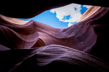 Canvas Print - Erosion of sandstone rocks and blue sky. Lower Antelope Canyon, Arizona, USA