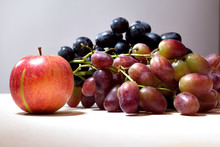 Ripe Red Apple And Grapes On Grey Background