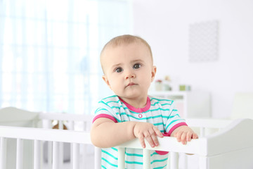 Sticker - Cute little baby standing in crib at home