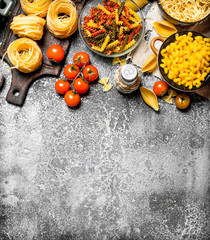 Wall Mural - Pasta background. Pasta with sauces, vegetables and olive oil.