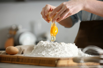 Poster - Female chef making dough in kitchen