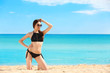 © Africa Studio - Beautiful young woman in bikini near sea on summer day