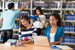 © DragonImages - Students in library