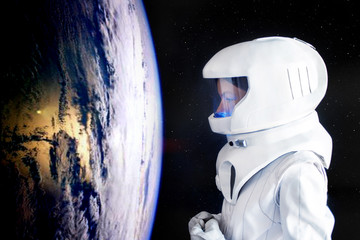 Wall Mural - Astronaut looking at Earth from spaceExploration of outer space. Elements of this image furnished by NASA.