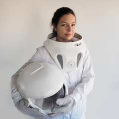 Wall Mural - Female astronaut on a white background. Fantastic space suit. Exploration of outer space.