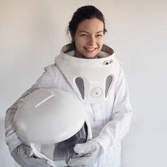 Wall Mural - Female astronaut on a white background. Fantastic space suit. Exploration of outer space.