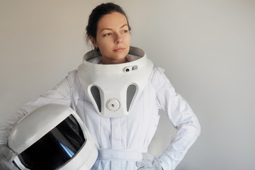 Wall Mural - Female astronaut on a white background. Fantastic space suit. Exploration of outer space.