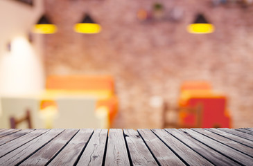 Wooden table top surface over blur kitchen cafe background