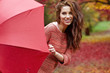 © ZoomTeam - Autumn woman in autumn park with red umbrella, scarf and leather gloves