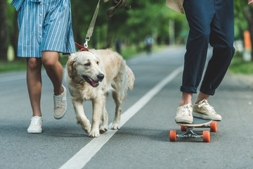 couple riding on board with dog