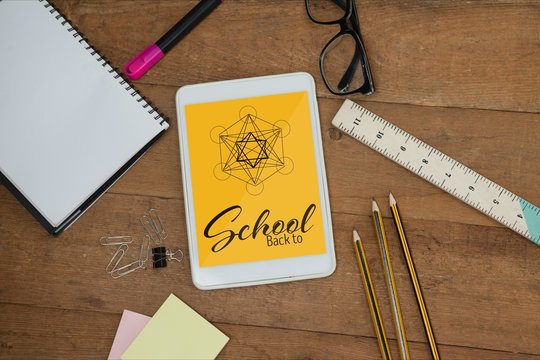 Tablet on a school table with school icons on screen