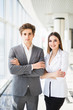 © F8  \ Suport Ukraine - Confident business team of man and woman standing with crossed hands, team spirit concept, couple of success business people ready to act, business manager and employee,ready to implement plans