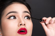 © makistock - Make-up and cosmetics concept. Asian woman doing her makeup eyelashes black mascara.