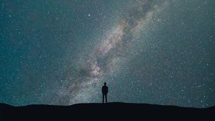 Wall Mural - The man stand on a background of a milky way with asteroids skyfall. time lapse