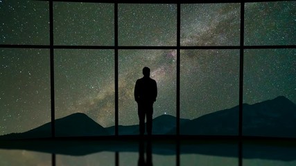 Wall Mural - The man stand in the hall on the starry sky background. time lapse, night time