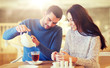 © Syda Productions - happy couple drinking tea at cafe
