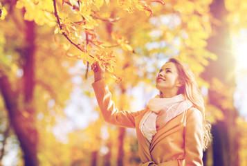 Sticker - beautiful happy young woman walking in autumn park