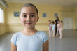 © Mark Edward Atkinson/Blend Images - Portrait of smiling girl in ballet studio