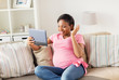 © Syda Productions - happy pregnant woman with tablet pc at home