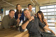 © Mark Edward Atkinson/Blend Images - Portrait of smiling friends drinking beer in brew pub