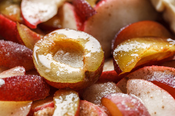 pie with plums near a window