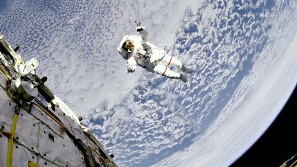 Wall Mural - Astronaut are flying near the space station in outer space against the Earth background. Elements of this image furnished by NASA.