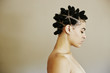 © Peathegee Inc/Blend Images - Profile of woman with Bantu knot hairstyle and eyes closed