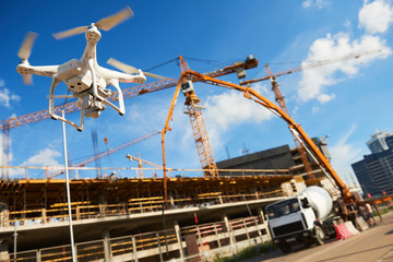 Wall Mural - drone over construction site. video surveillance or industrial inspection