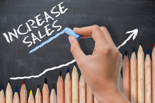 Sales Increase Concept Or Target On Chalkboard With Wave Of Colored Pencils