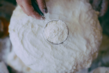 Close up view of baker kneading dough. Homemade bread. Hands preparing bread dough on wooden table. Preparing traditional homemade bread. Woman hands kneading fresh dough for making bread