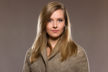 Young caucasian woman headshot against light background