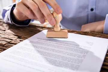 Wall Mural - Person Holding Stamp On Document