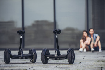 Teenage couple with gyro scooters