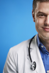 Wall Mural - Smiling white male doctor with stethoscope, vertical, crop