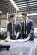 © Blue Jean Images - Businessmen talking in the factory