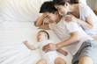 © Blue Jean Images - Young parents with sleeping baby boy