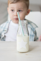 Сute little boy is eating candy and drinking milk. Health. Happy child. Breakfast. 