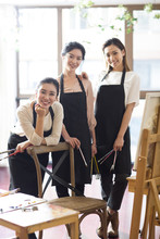 Young Women Painting In Studio