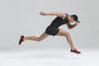 © Blue Jean Images - Male athlete running against white background